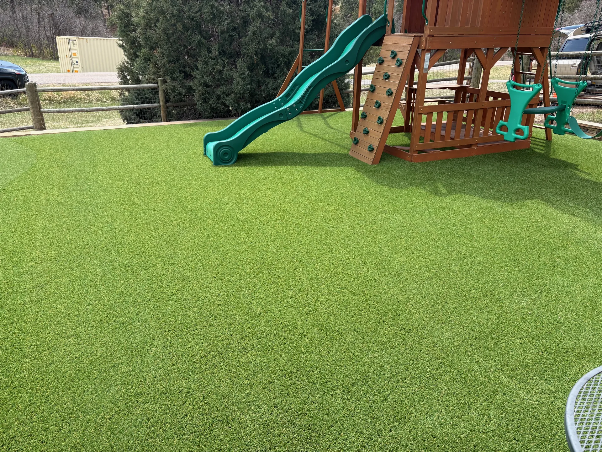 Family-friendly backyard artificial turf beside a playground in Colorado